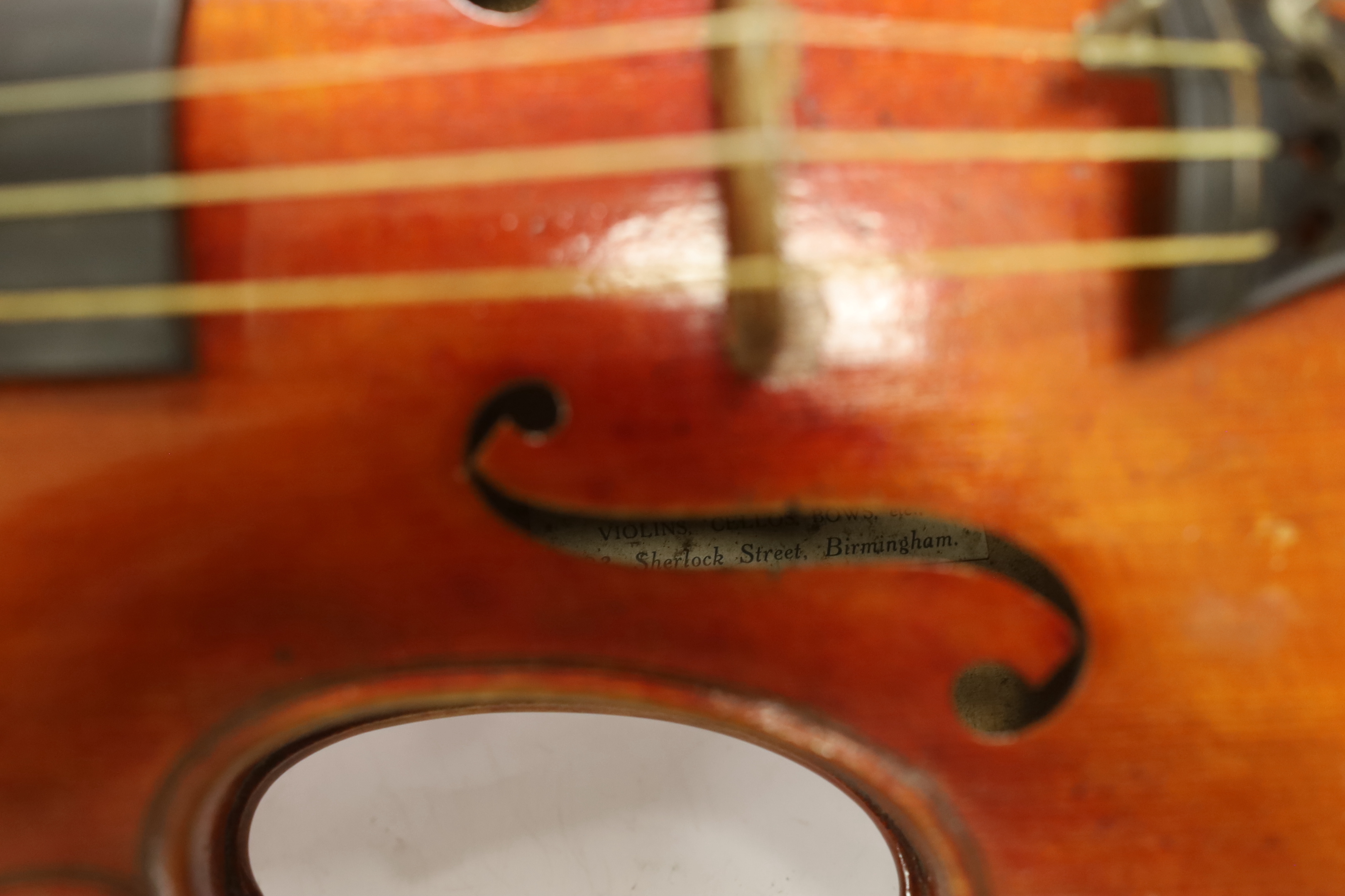 A French violin, c. 1900, with a retailer’s label inside the body for Thomas Smith, 183 Sherlock St. Birmingham, cased with a bow, body 35.5cm